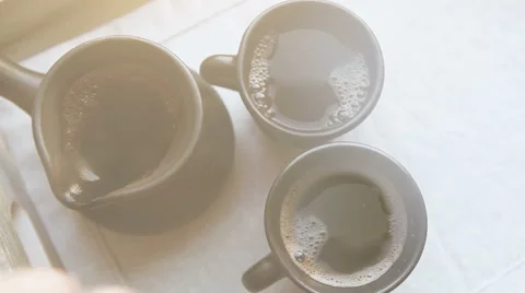 Two black coffee cups and clay ibrik on the wooden salver Stock Footage 64213342