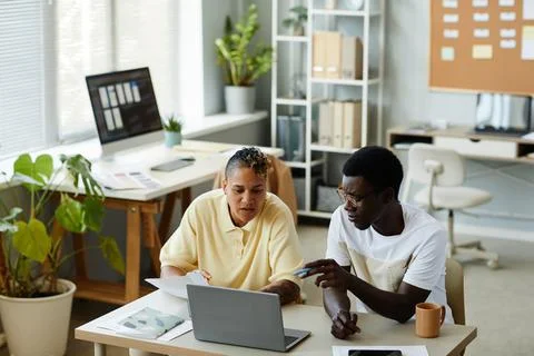 Two Black Colleagues Collaborating On Project Stock Photos