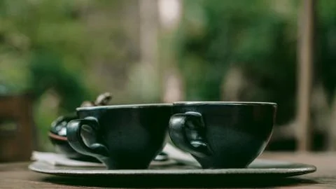 Two black cups of coffee on a table Stock Photos