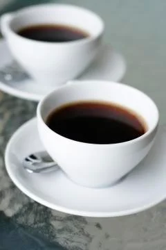 Two black filter coffees in white cups. Stock Photos