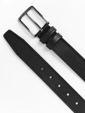 Two black leather belts coiled side by side view Stock Photos