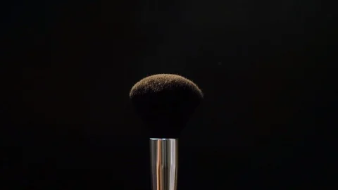 Two black makeup brushes with powder or blush on a dark background. Beauty conce Stock Footage 118223214