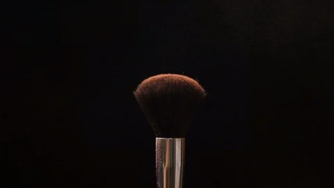 Two black makeup brushes with powder or blush on a dark background. Beauty conce Stock Footage 118224418