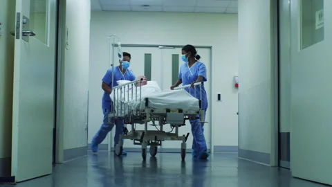 Two black nurses in the hospital taking an elderly man to his room Stock-Footage 264097034