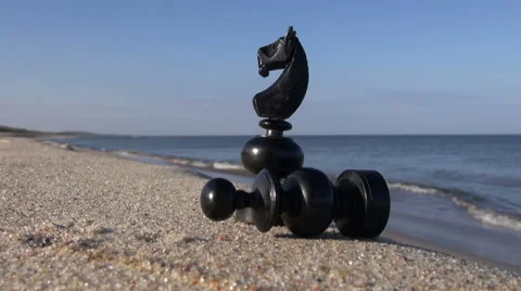 Two black retro chess pieces on sea resort beach sand Stock Footage 43672497