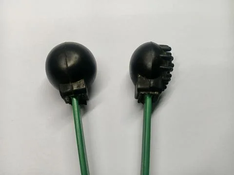 Two black rubber ends of an indoor television antenna Stock Photos