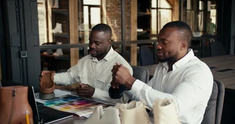 Two Black-skinned men in white shirts, a shoe factory manager and a shoe Stock Footage 246417222