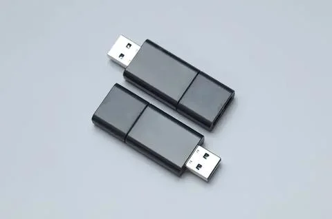 Two black usb flash drives on gray background Stock Photos
