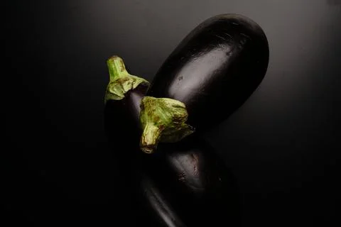 Two black zucchini on a black background top view. Foto stock