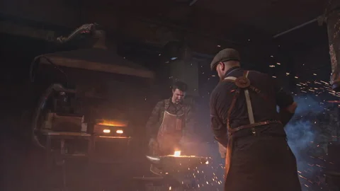 Two blacksmiths take turns striking the red-hot metal Stock-Footage 146580644