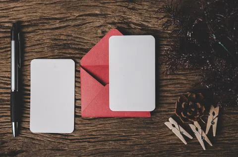 Two blank card with red envelope and pen is placed on wood. Stock Photos