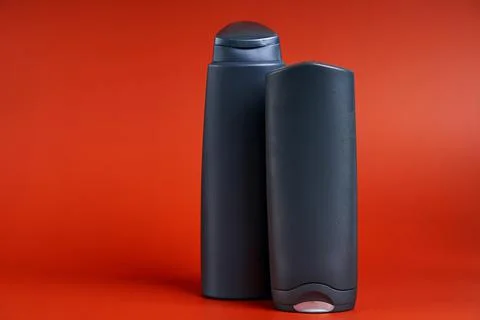 Two blank dark plastic container of shower gel or shampoo Stock Photos