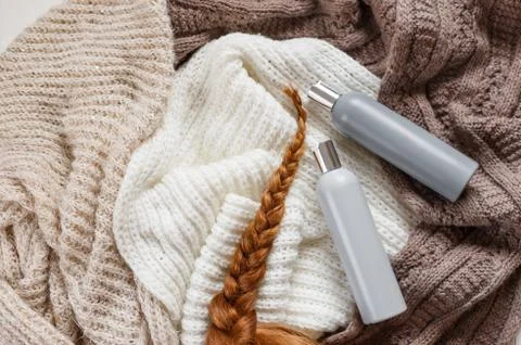 Two blank plastic bottles with shampoo and red hairs of young woman lying on  Stock Photos