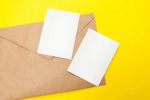 Two blank postcard with brown envelope on yellow background Stock Photos