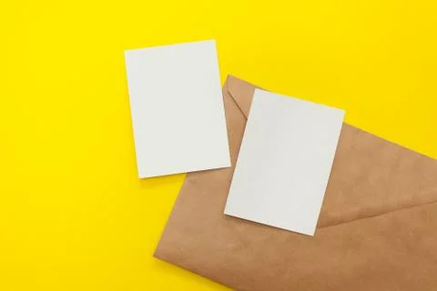 Two blank postcard with brown envelope on yellow background Stock Photos