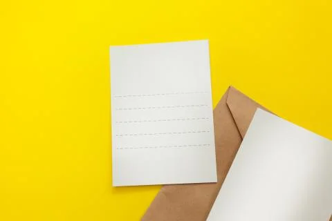 Two blank postcard with brown envelope on yellow background Stock Photos
