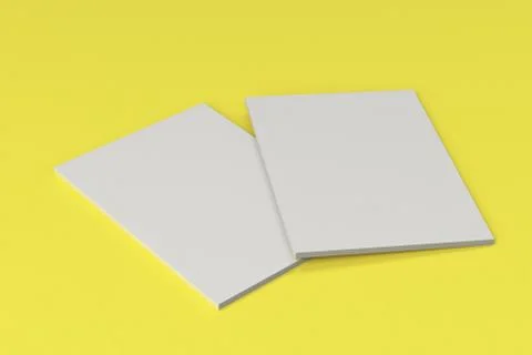 Two blank white closed brochure mock-up on yellow background Stock Illustration