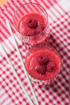 Two blended thick smoothie from raspberry with tubule Stock Photos