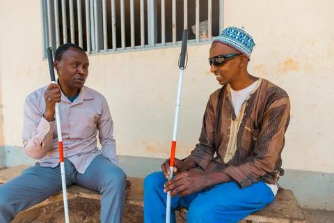 Two blind men sitting on a bench are having a conversation, friendship betw.. Stock-Fotos