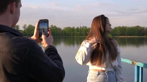 Two bloggers create content for their blog by taking photos on their smartphone. Stock Footage 310487562