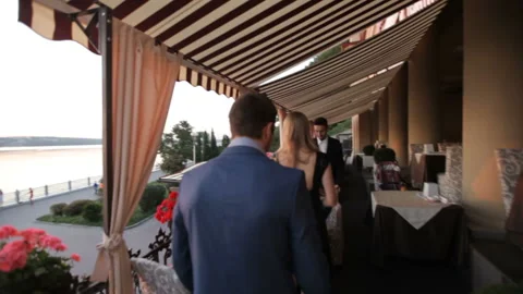 Two blondes came on a romantic date with two guys in a summer cafe on the Stock Footage 113522267