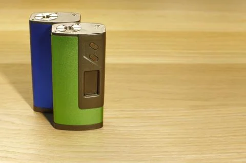 Two blue and green boxmod devices for vaping (electronic cigarette) on the .. Stock Photos