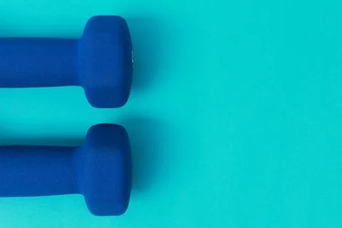 Two blue barbells on a blue background Stock Photos
