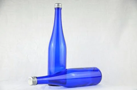 Two blue bottles with silver caps (mockup) Stock Photos
