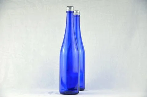 Two blue bottles with silver caps (mockup) Foto stock