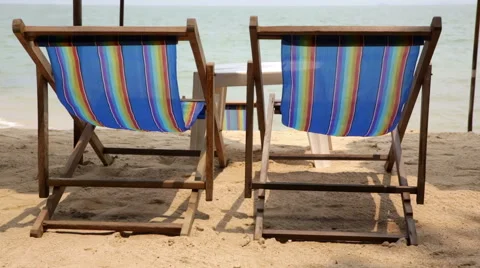 Two blue deck chairs on beach with blue sea Vídeo Stock 49136649