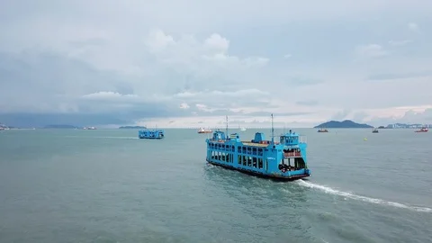 Two blue ferry move in different direction. Background is Penang Bridge. Видео 119030700