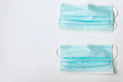 Two blue masks on a white table Stock Photos