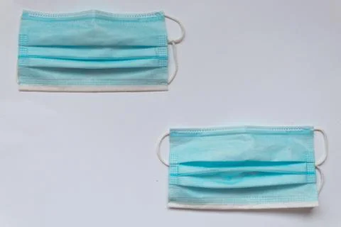 Two blue masks on a white table Stock Photos