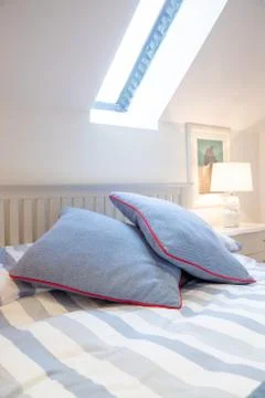 Two blue pillow on a bed Stock Photos