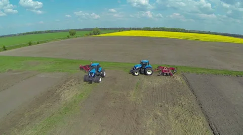 Two blue tractor on field work. Aerial view. Video stock 37669770