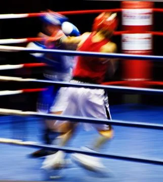 Two blurring boxers fighting at the ring Stock Photos