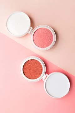 Two blushes for make-up in the form of a cushion on dowble background Stock Photos