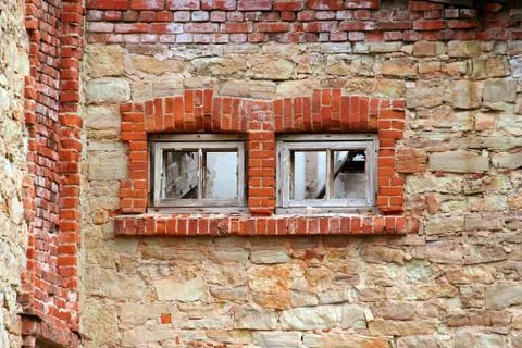 Two boarded up windows in an old abandoned building Stock Photos