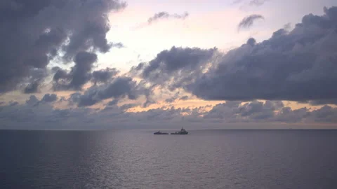 Two Boat Silhouettes while refill fuel at Sunset Over Sea.Orange Red Color Sunri Stock Footage 160199124