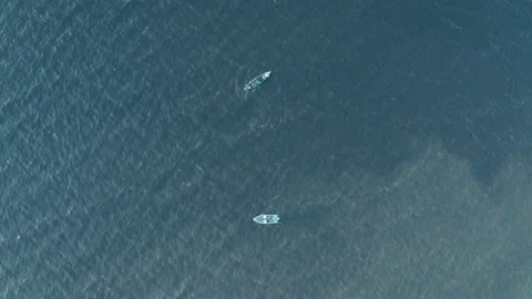 Two boats float in different directions in the sea on the waves. 스톡 동영상 165405875