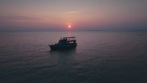 Two boats floating peacefully on calm waters during stunning sunset, casting Stock Footage 312746982