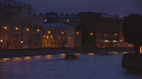 Two boats go through the canals in the city in the evening Stock-Footage 77235612