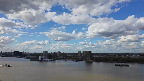 Two boats navigating past one another on the River Thames, with clouds drifting Stock Footage 333942241
