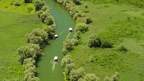 Two Boats Navigating Wetland Channel at Skadar Lake, Montenegro Stock Footage 344969696
