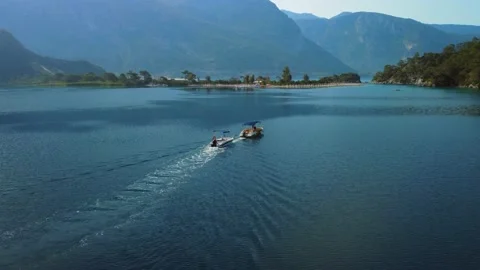 Two boats, one after one, crossing the Oludeniz Bay in Fethiye Turkey. Stock Footage 196984915