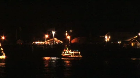 Two boats pass decorated with lights pass at festival Stock Footage 295370