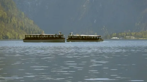 Two boats pass each other on the lake in the mountains. Stock Footage 75165975