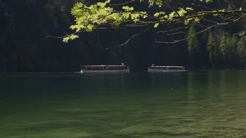 Two boats pass each other on the lake in the mountains. Stock Footage 75166650