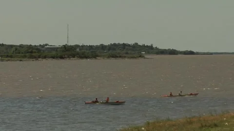 Two boats rowing on a broad river Stockbeeldmateriaal 160257414