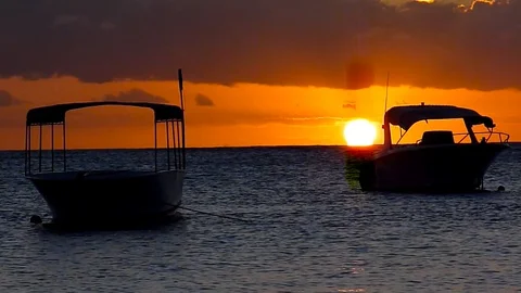Two boats at sunset floating on indian ocean, Grand Baie, Mauritius Island Stock-Footage 128917561